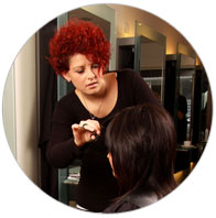 Girl with red hair cutting someones hair